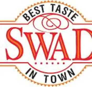 A logo with the words "best taste swad in town" displayed in a circular design, featuring an orange and red color scheme and a graphical element that resembles a stylized knot or twist at the top center. A logo with the words "best taste swad in town" displayed in a circular design, featuring an orange and red color scheme and a graphical element that resembles a stylized knot or twist at the top center.